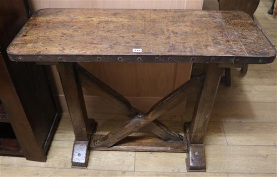An iron bound oak shove halfpenny table, W.100cm
